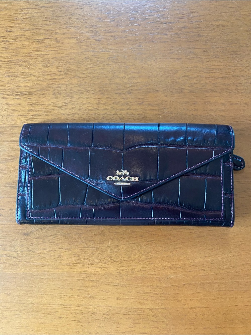 Coach Croc-Embossed Burgundy Leather Envelope Wallet with Gold Label.